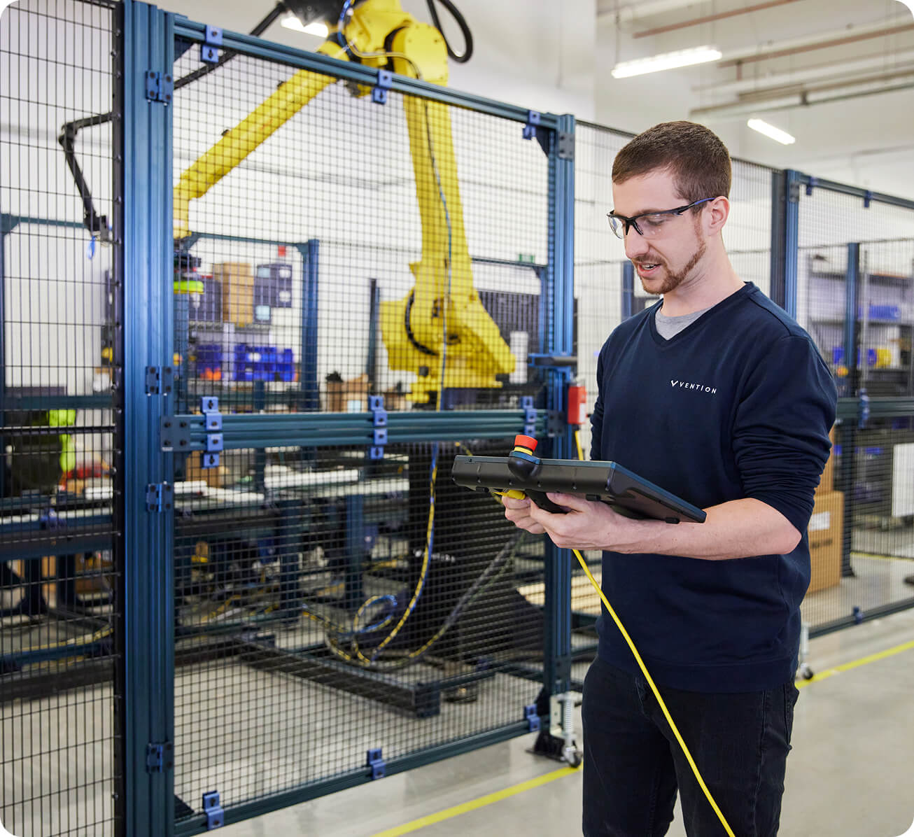 Vention engineer working with automation equipment